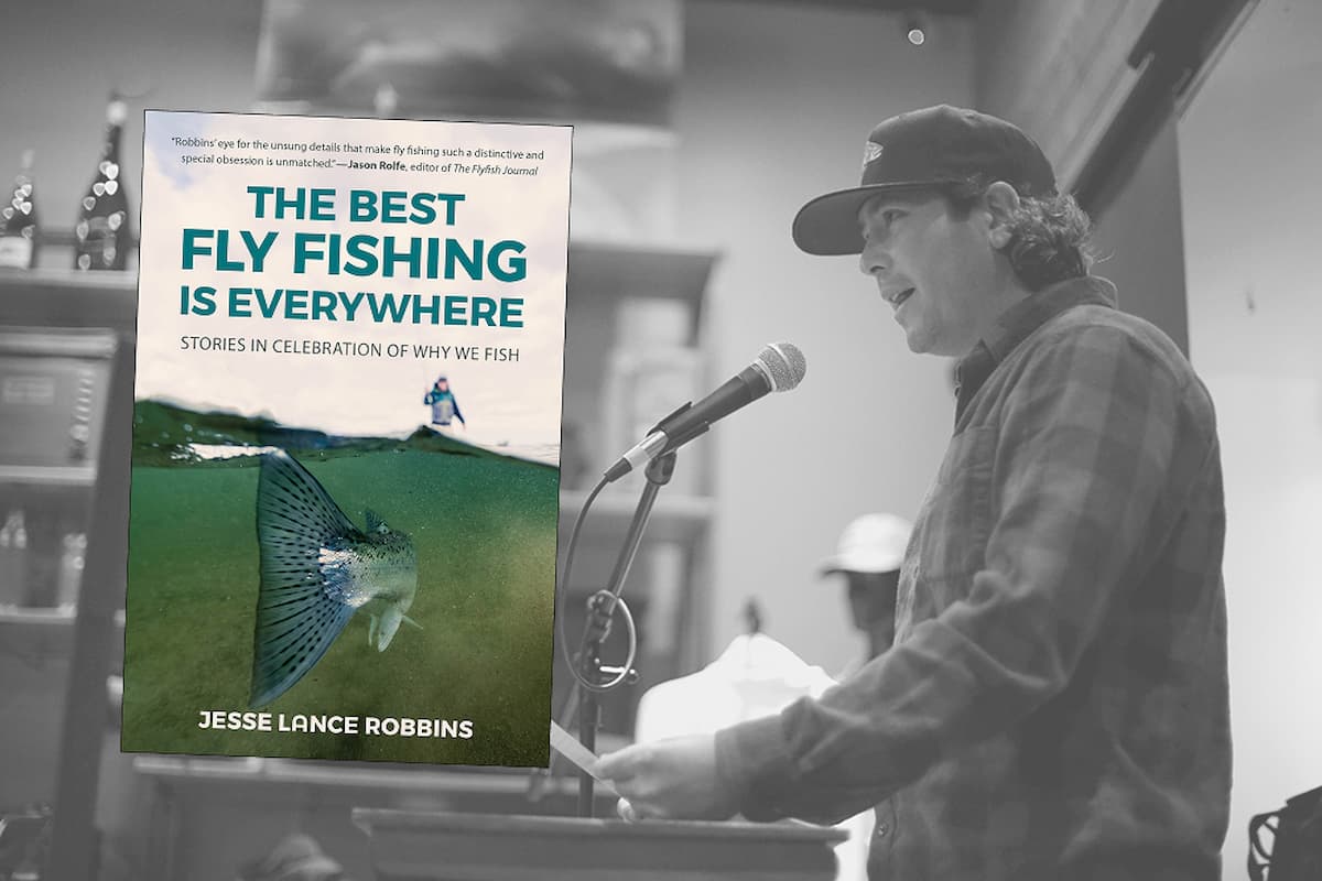 Jesse Lance Robbins speaks at a podium beside an overlay of the cover of his book, "The Best Fly Fishing Is Everywhere: Stories in Celebration of Why We Fish."