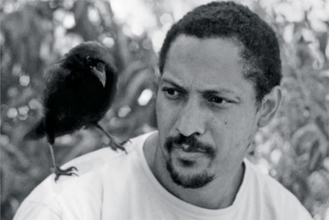 The author Percival Everett with a crow perched on his shoulder