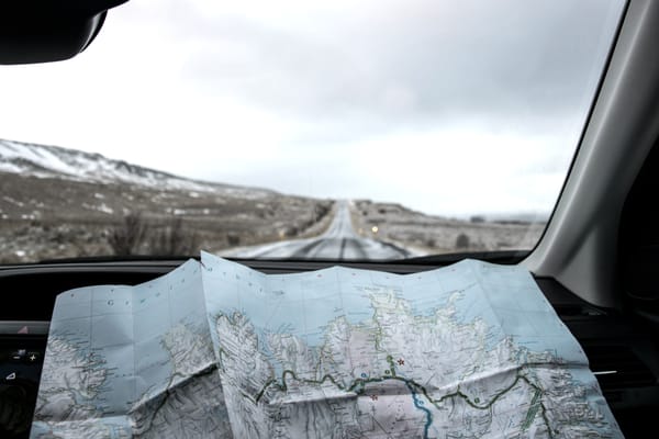 an unfolded map on the dashboard of a car 
